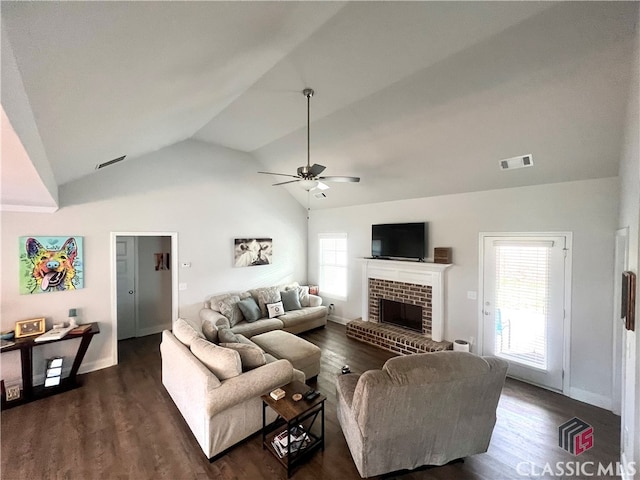 living room with ceiling fan, a brick fireplace, a healthy amount of sunlight, and dark hardwood / wood-style floors