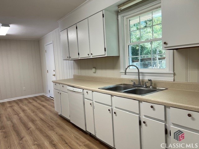 kitchen featuring dishwasher, sink, crown molding, white cabinets, and light hardwood / wood-style floors