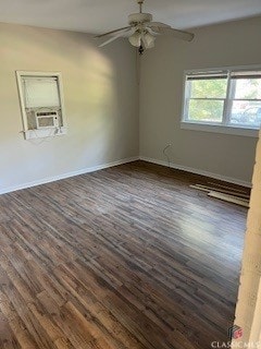 spare room featuring cooling unit, ceiling fan, and dark hardwood / wood-style flooring