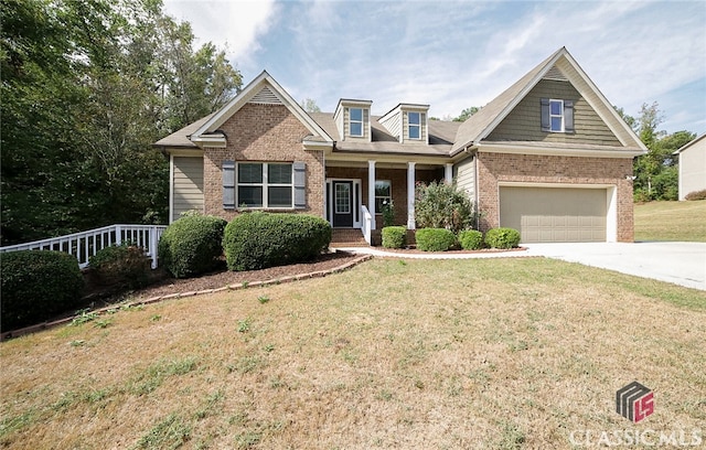 craftsman inspired home featuring a porch, a garage, and a front yard