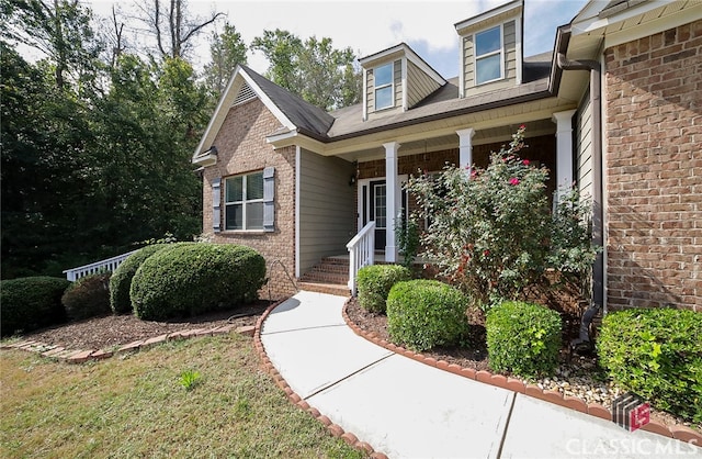 doorway to property featuring covered porch