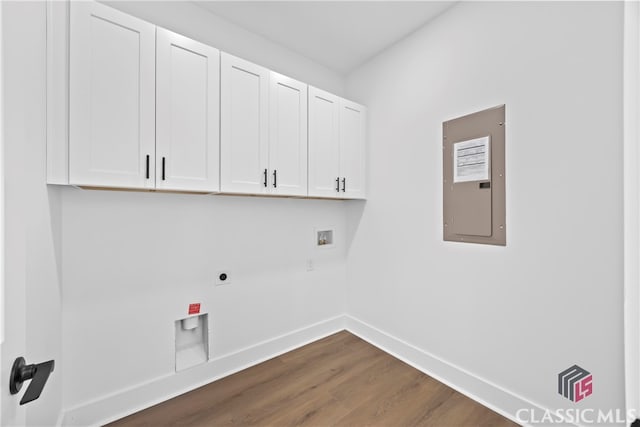 washroom featuring cabinets, washer hookup, hookup for an electric dryer, dark wood-type flooring, and electric panel