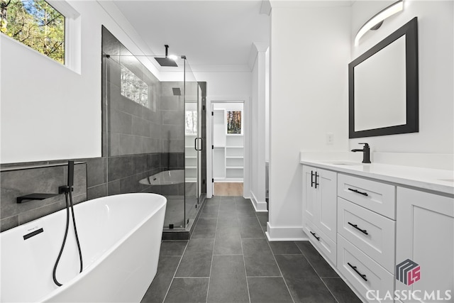 bathroom featuring tile patterned flooring, vanity, separate shower and tub, and crown molding