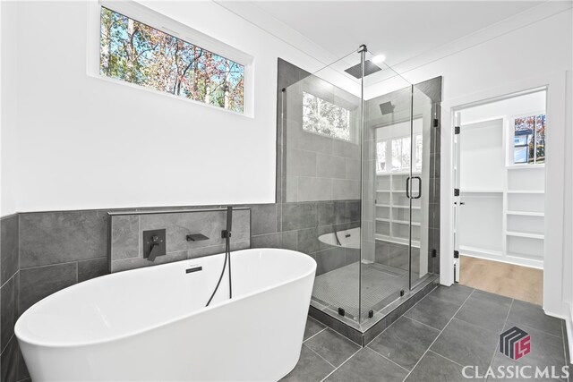 bathroom with tile patterned floors, ornamental molding, and independent shower and bath