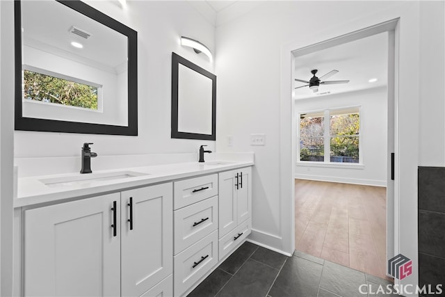 bathroom with hardwood / wood-style flooring, ceiling fan, ornamental molding, and vanity