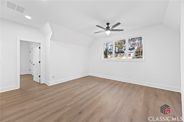 additional living space featuring light wood-type flooring, ceiling fan, and lofted ceiling