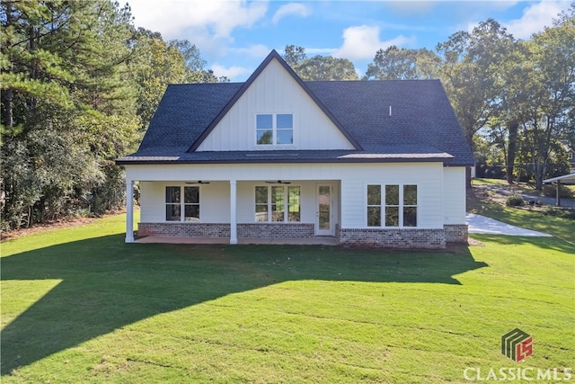 rear view of house with a lawn and ceiling fan