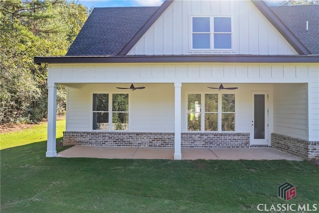 rear view of house featuring a lawn