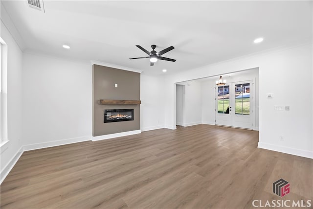 unfurnished living room with ceiling fan, hardwood / wood-style floors, french doors, and ornamental molding