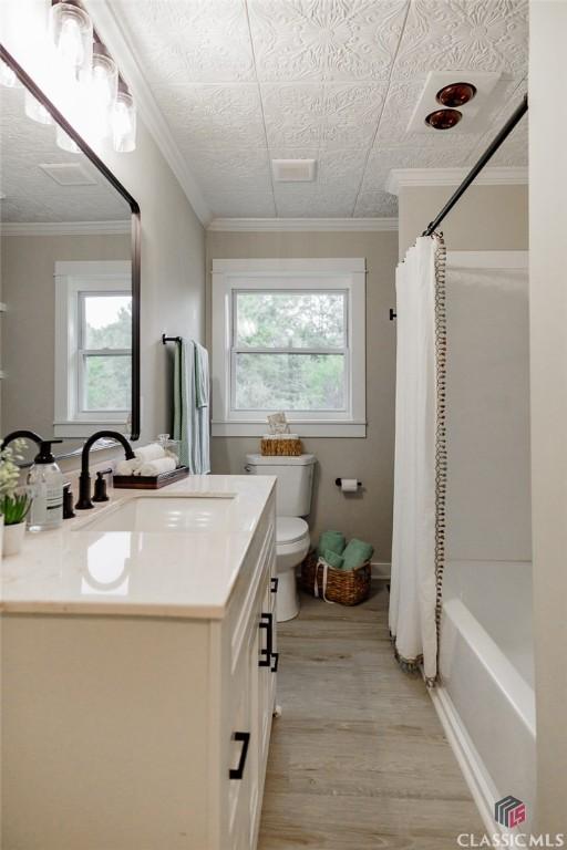 1471 Lenru Rd, Bogart, GA 30622 - bathroom with toilet, plenty of natural light, vanity, and wood finished floors