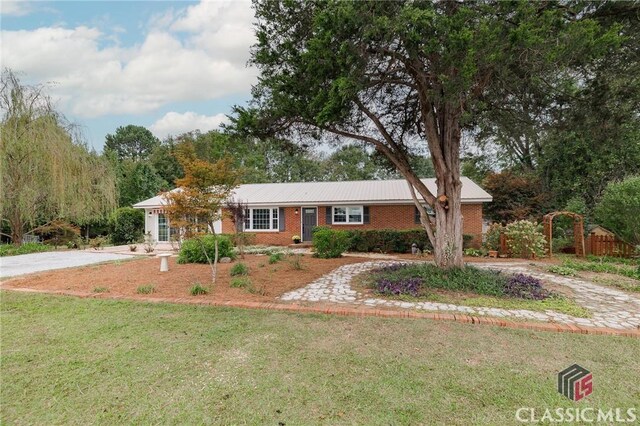 1471 Lenru Rd, Bogart, GA 30622 - single story home featuring metal roof, brick siding, a front lawn, and curved driveway