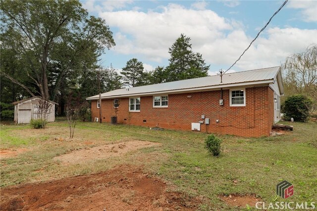1471 Lenru Rd, Bogart, GA 30622 - back of property featuring brick siding, metal roof, an outdoor structure, and a storage unit