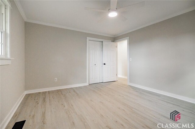 1471 Lenru Rd, Bogart, GA 30622 - unfurnished bedroom with ornamental molding, baseboards, a closet, and wood finished floors