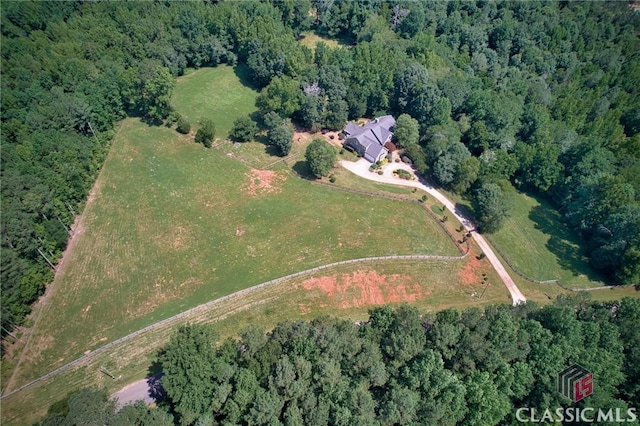 birds eye view of property with a view of trees