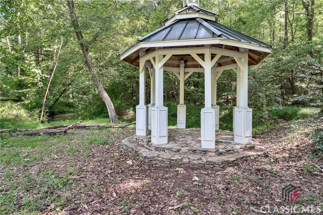 surrounding community featuring a wooded view and a gazebo