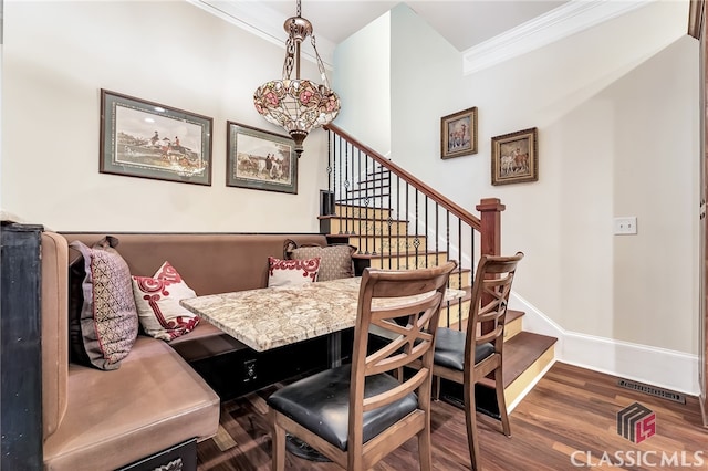 dining room featuring ornamental molding and dark wood-type flooring