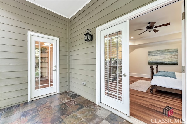 view of exterior entry featuring ceiling fan