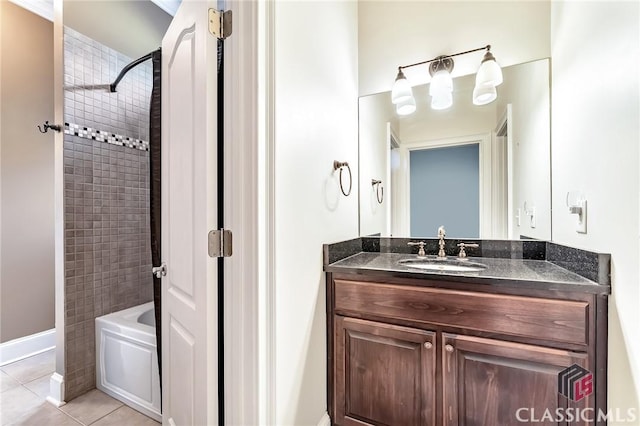bathroom featuring baseboards, tile patterned flooring, tub / shower combination, and vanity