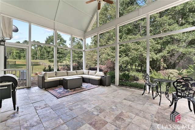 sunroom featuring outdoor lounge area, ceiling fan, and plenty of natural light