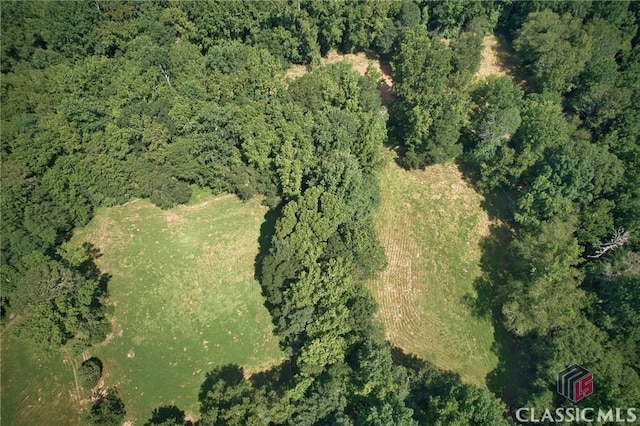 birds eye view of property featuring a wooded view