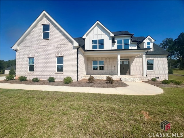 view of front of house featuring a front yard and covered porch