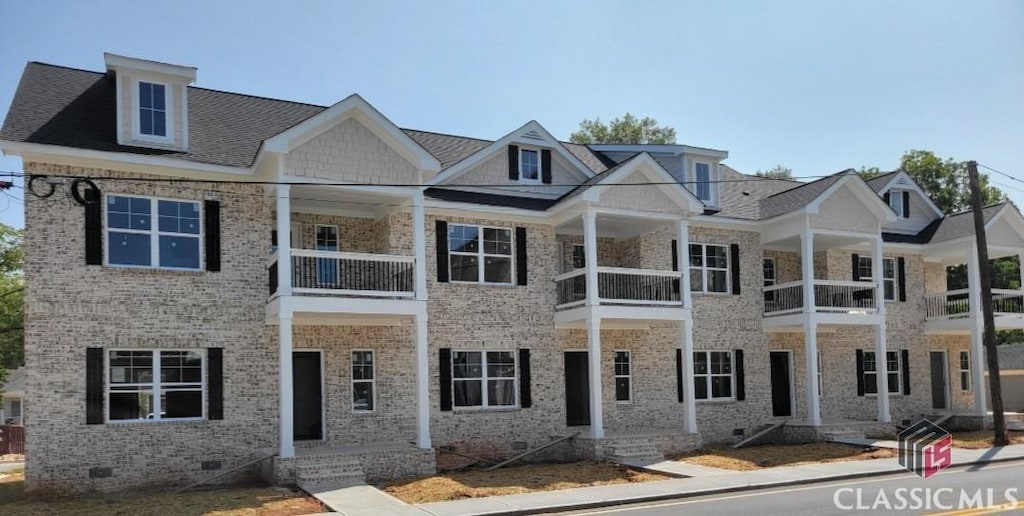 319 Madison Ave S, Monroe, GA 30655 - view of front of house with a balcony, brick siding, and crawl space