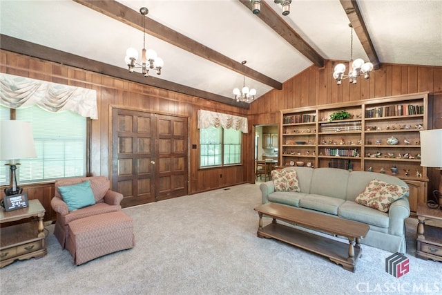 carpeted living room featuring an inviting chandelier, wood walls, and lofted ceiling with beams