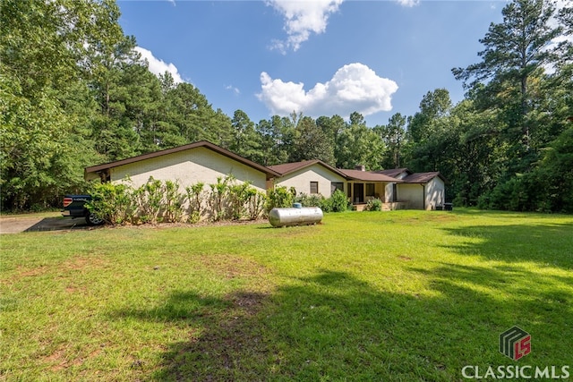 single story home featuring a front lawn and a shed