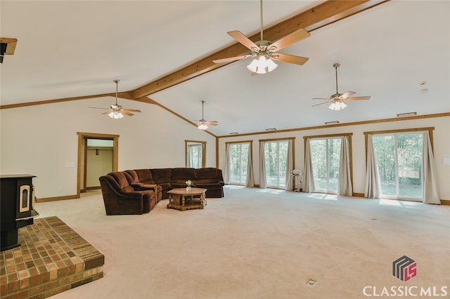 carpeted living room featuring high vaulted ceiling, beam ceiling, a wood stove, and a wealth of natural light