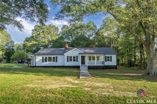 218 E Vine St, Monroe, GA 30655 - single story home featuring a front yard, a porch, crawl space, and a chimney