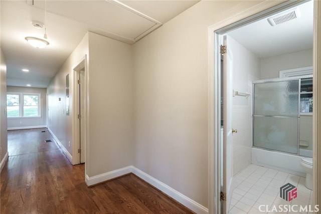 218 E Vine St, Monroe, GA 30655 - hall with visible vents, baseboards, attic access, and wood finished floors