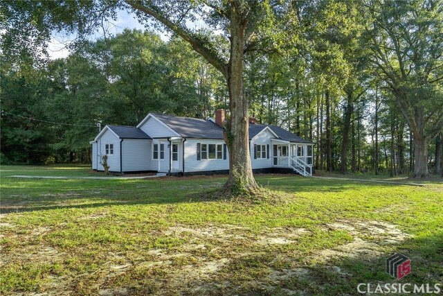 218 E Vine St, Monroe, GA 30655 - view of front facade featuring a chimney and a front yard