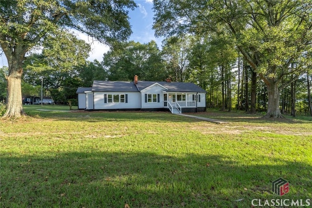 218 E Vine St, Monroe, GA 30655 - view of front of house featuring a front yard and a chimney