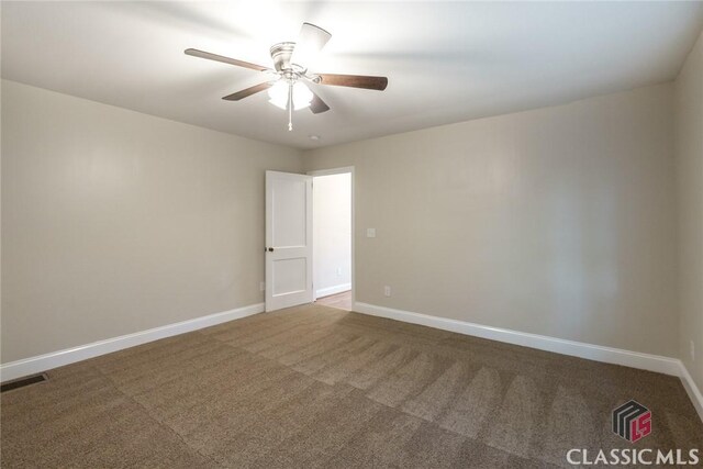 218 E Vine St, Monroe, GA 30655 - carpeted empty room featuring visible vents, baseboards, and a ceiling fan
