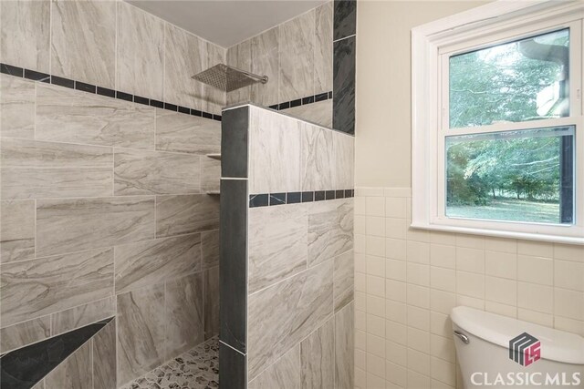 218 E Vine St, Monroe, GA 30655 - bathroom featuring tile walls, walk in shower, and toilet