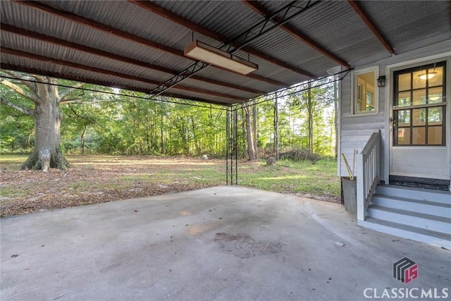 218 E Vine St, Monroe, GA 30655 - view of vehicle parking featuring a carport and entry steps
