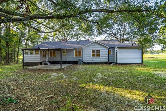 218 E Vine St, Monroe, GA 30655 - rear view of house featuring a yard, entry steps, and a patio