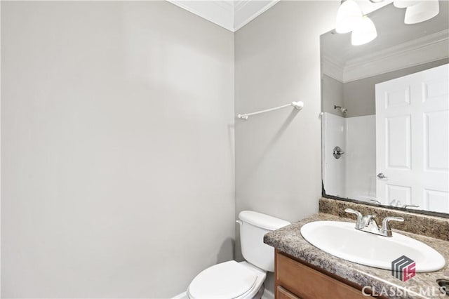 bathroom featuring vanity, ornamental molding, toilet, and walk in shower