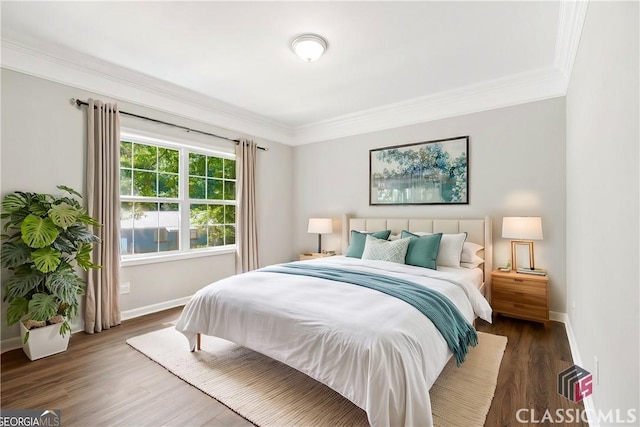 bedroom with crown molding and dark hardwood / wood-style floors