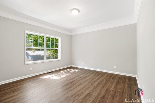 empty room with crown molding and dark hardwood / wood-style floors