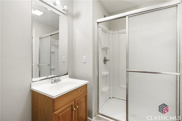 bathroom featuring walk in shower and vanity