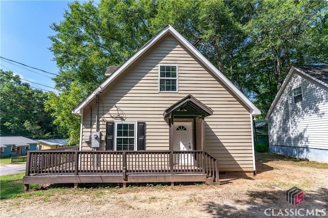 bungalow-style home with a wooden deck