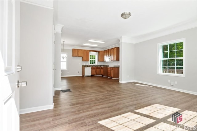 unfurnished living room featuring crown molding and light hardwood / wood-style floors