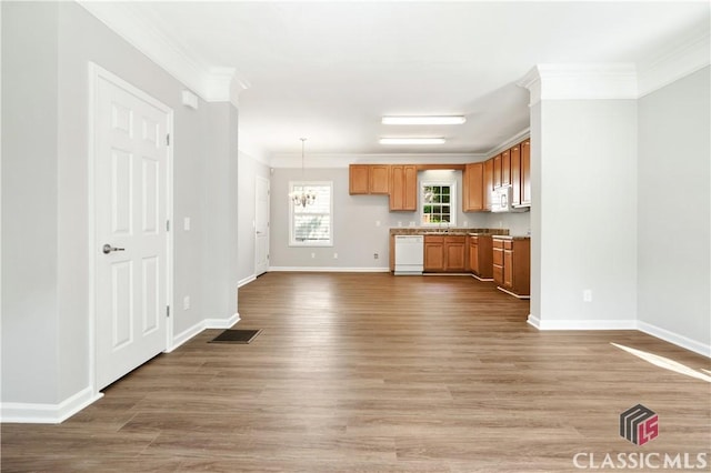 kitchen with hardwood / wood-style flooring, ornamental molding, white appliances, and decorative light fixtures