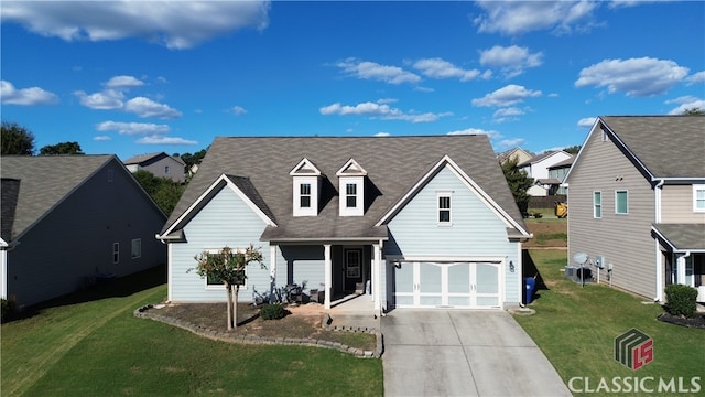 view of front of property featuring a front yard and a garage