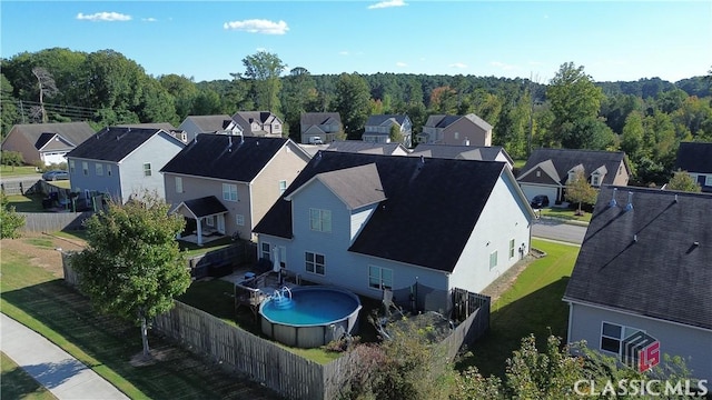 birds eye view of property with a forest view and a residential view