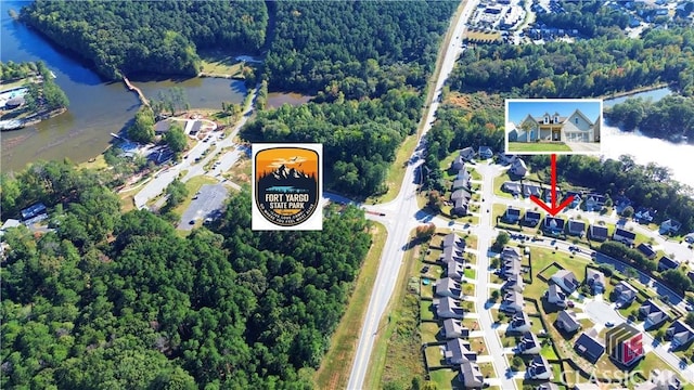 drone / aerial view featuring a forest view and a water view