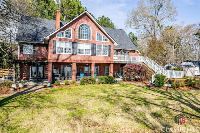 rear view of property with a lawn