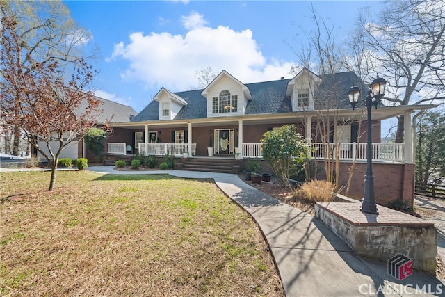 cape cod house with a front lawn and a porch