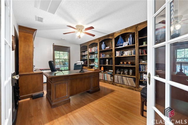 home office featuring a textured ceiling, hardwood / wood-style floors, and ceiling fan